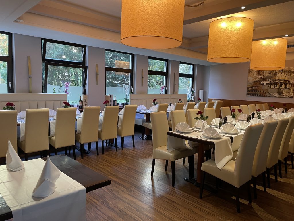 Stilvoll gedeckter langer Tisch für Gruppen und Feiern im italienischen Restaurant Roma